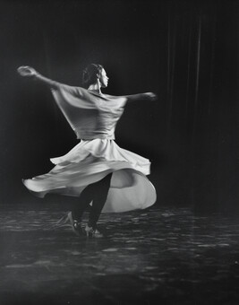 Untitled, Pilobolus performance (Female dancer spinning with skirt billowing out in a circle)