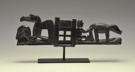 Argillite Ship Panel Pipe with a Spray of Foliage surmounted by a Dog or Wolf; a seated  Anglo-European...