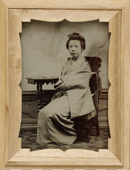 Portrait of a Geisha Seated Before a Table