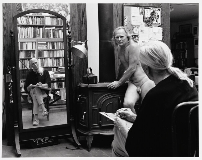 Paul Cadmus and Jon Anderson in the Studio (Jon posing against the woodstove, Paul sketching)