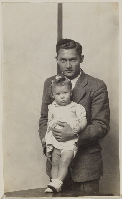 Standing Man Holding a Small Girl on a Table