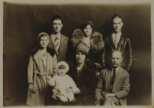 Perhaps a Family Portrait: Two Young Couples, Older Couple, and Toddler Girl (all in winter attire)