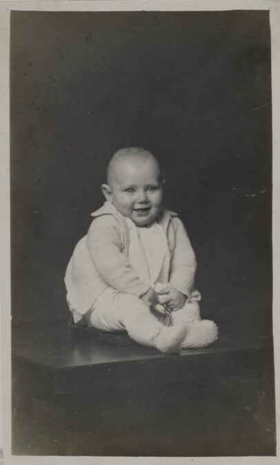 Gary Wayne Kendell (smiling baby seated on a table)