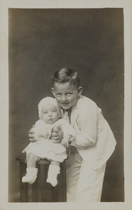 Boy Holding a Baby (leaning in and hugging)