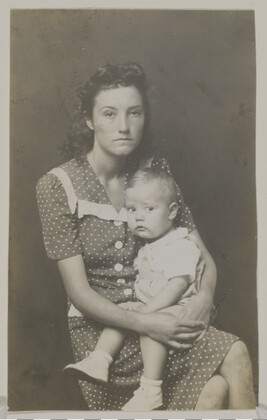 Woman in Polka Dot Dress, Holding a Toddler on her Lap