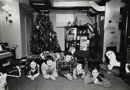 Christmas, A Policeman, his Family and a Neighborhood Friend in the Basement Playroom of their House