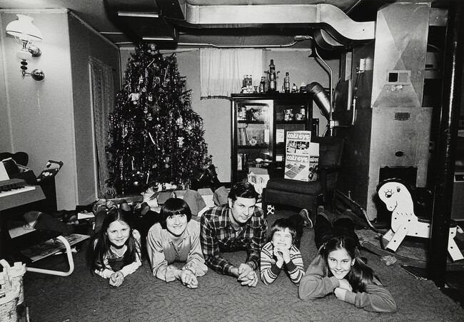 Christmas, A Policeman, his Family and a Neighborhood Friend in the Basement Playroom of their House