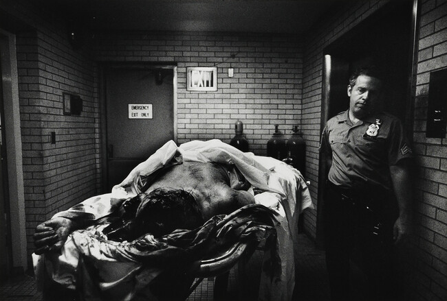 Woman who jumped to her death with hypodermic syringe in her hand is searched by a policeman in morgue; all police must take their turn at this kind of work; 9th Police Precinct, Homicide Task Force under Detective Sgt. Gerald Mc Queen(the real Kojak), New York City