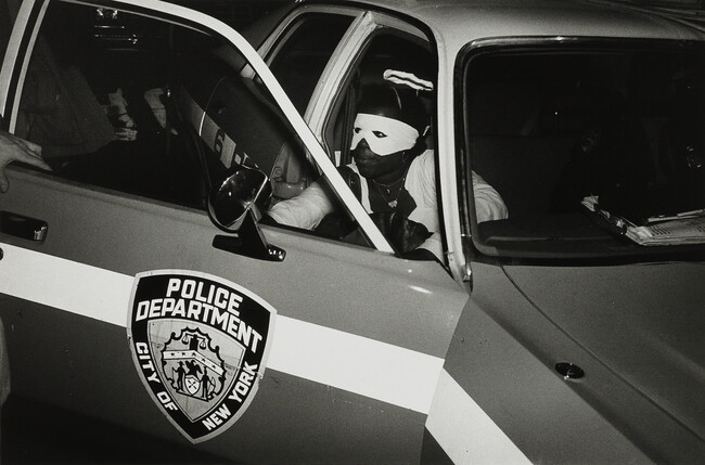 Halloween. A Young Man Dressed as an Angel seeks a Ride in a Patrol Car