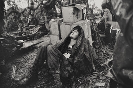 A U. S. Paratroooper Wounded in the Battle for Hamburger Hill Grimaces in Pain as he Awaits Medical...