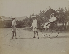 Woman with a parasol in a rickshaw pulled by two Japanese men. Kamakura, Kanagawa Prefecture, Japan,...
