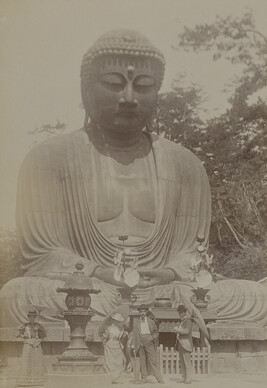 Two men and two women in front of the Daibutsu (Great Buddha) of Kōtoku-in. Kamakura, Kanagawa...