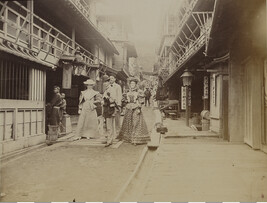 Four Western tourists and Japanese children on a street. Enoshima, Kanagawa Prefecture, Japan, from a...