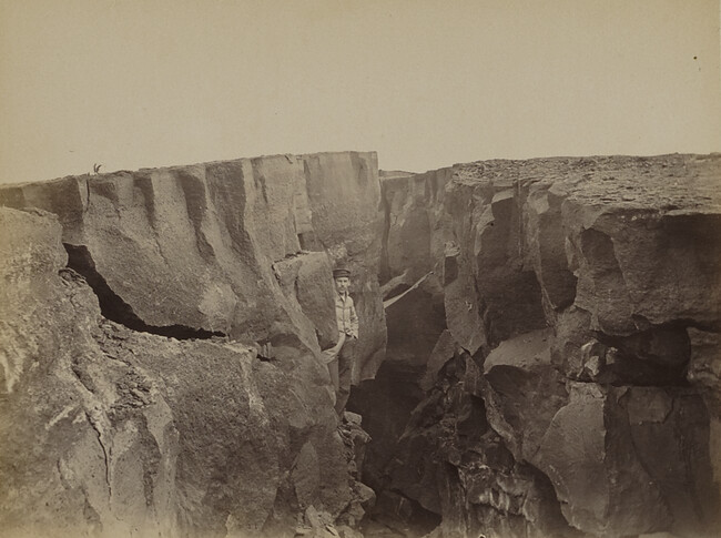 Man standing in a crack in a crater of Kīlauea. Hawaii (island), Hawaii, from a Travel Photograph Album (Views of Hawaii and Japan)