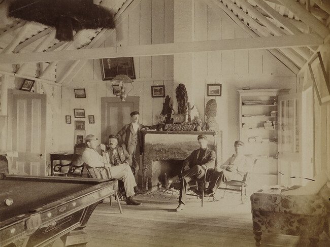 Five men in the lounging room at Volcano House. Hawaii (island), Hawaii, from a Travel Photograph Album (Views of Hawaii and Japan)