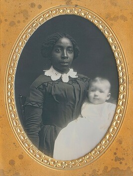 African American Woman holding a White Infant