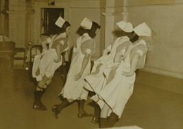 Men Dressed as Nurses Dancing in a Row with Backs to Camera