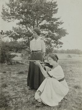 Standing Woman and Crouching Woman Shooting Rifle