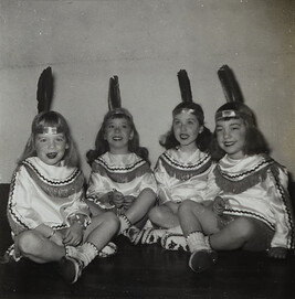 Four Young Girls with Headbands with Feathers