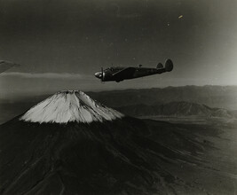 Airplane Flying with Snow Capped Mount Fuji in Background