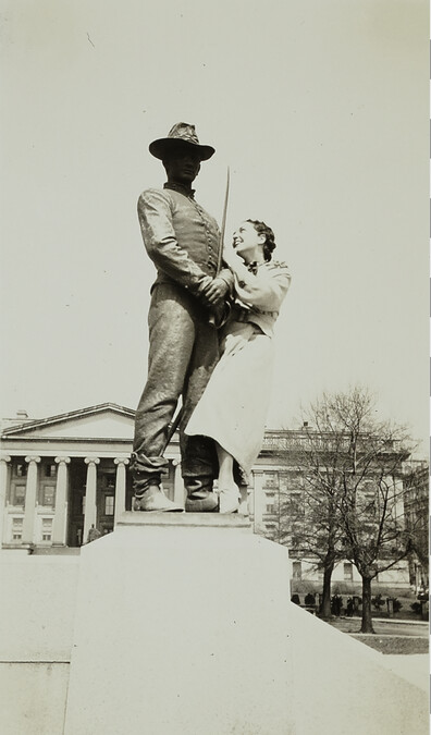 Woman Posing with a Statue