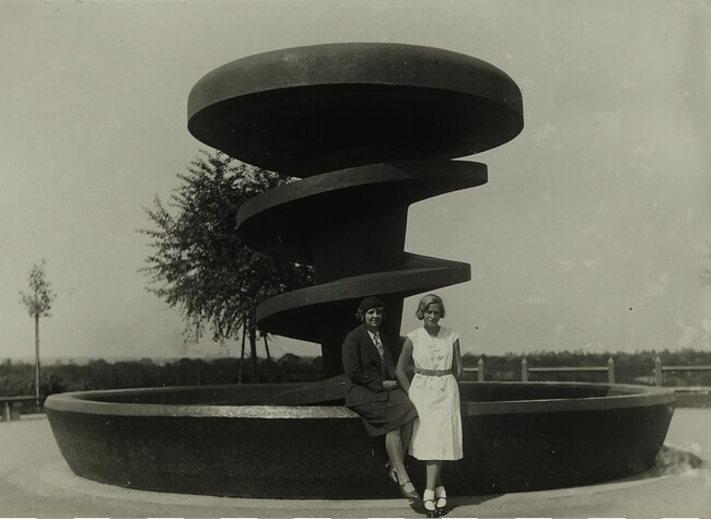 Two Women in Front of Modern Fountain