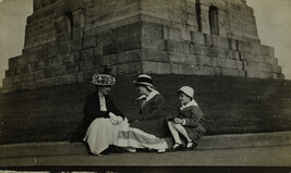 Three Women Sitting at Bottom of Statue of Liberty