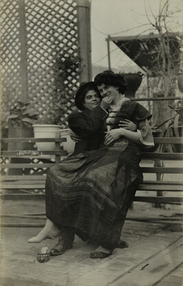 Crossed-Dressed Couple, Man sitting on Woman’s Lap